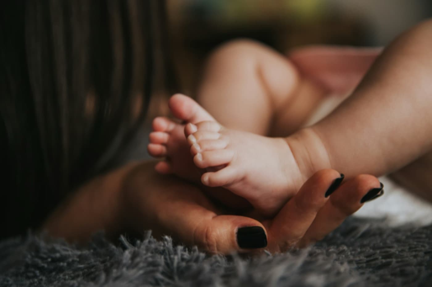 A close-up of a baby's feet resting gently